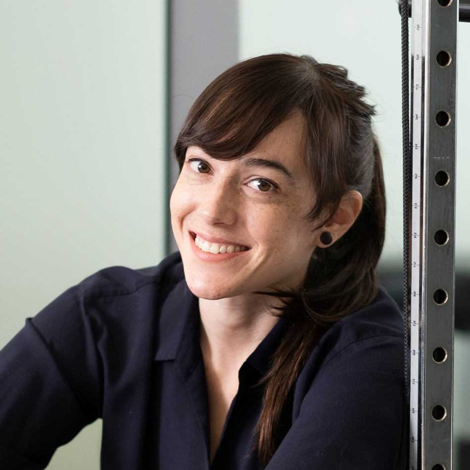 Photograph close up Alex Ruth leaning against gym equipment