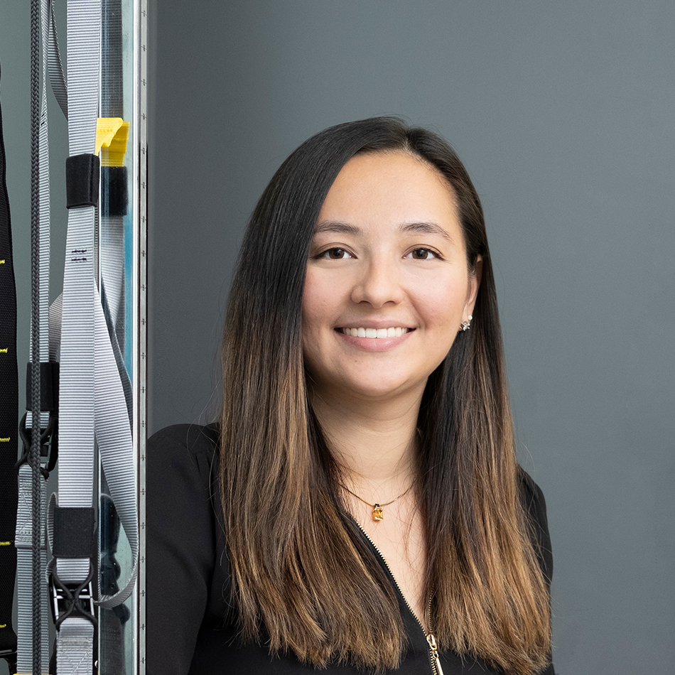 Photograph Grace Underwood leaning against gym equipment