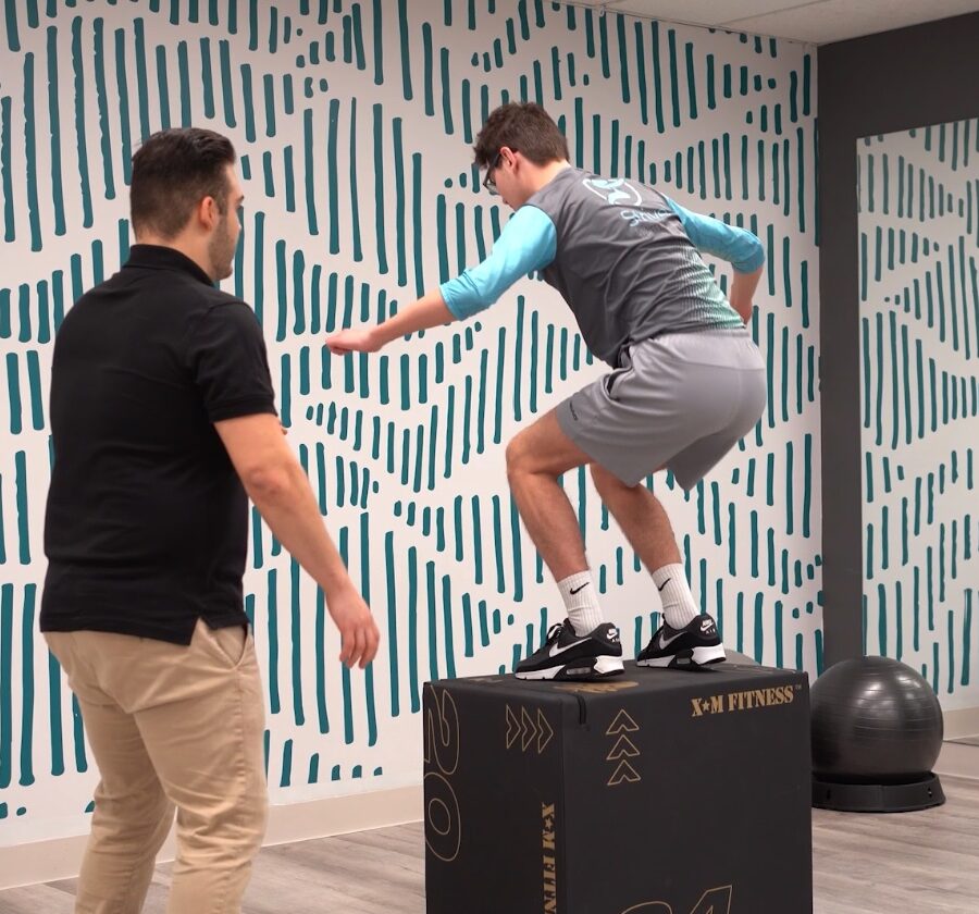 Physiotherapist supervising advanced Achilles tendon rehabilitation exercises at Strive Physiotherapy Toronto